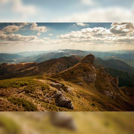 Overlay the original landscape image over its square blurred version to extend the image appearance vertically